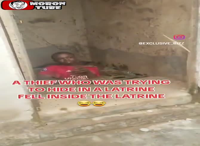 Video :While attempting to conceal in a public restroom, a robber slips into a latrine